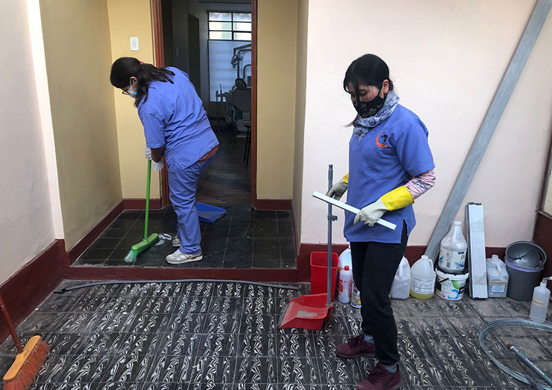 Two employees are cleaning the new location