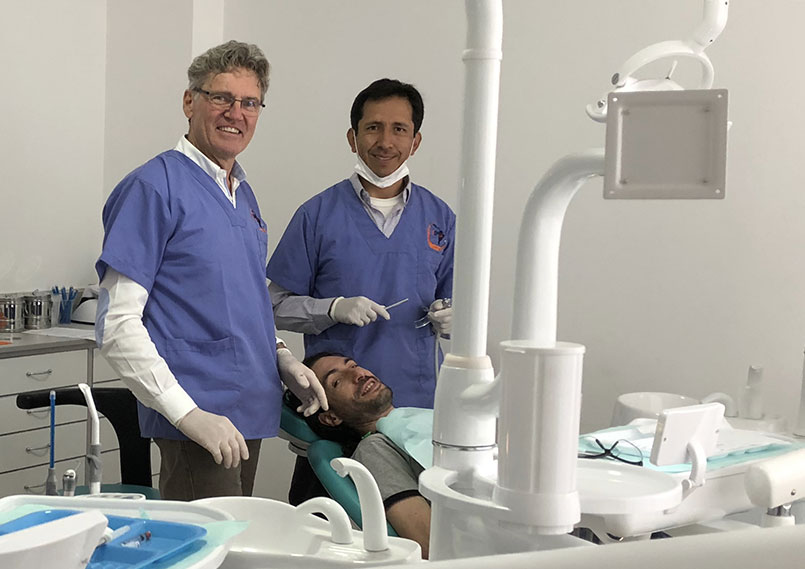 The two dentists at work treating a patient in the new dental clinic